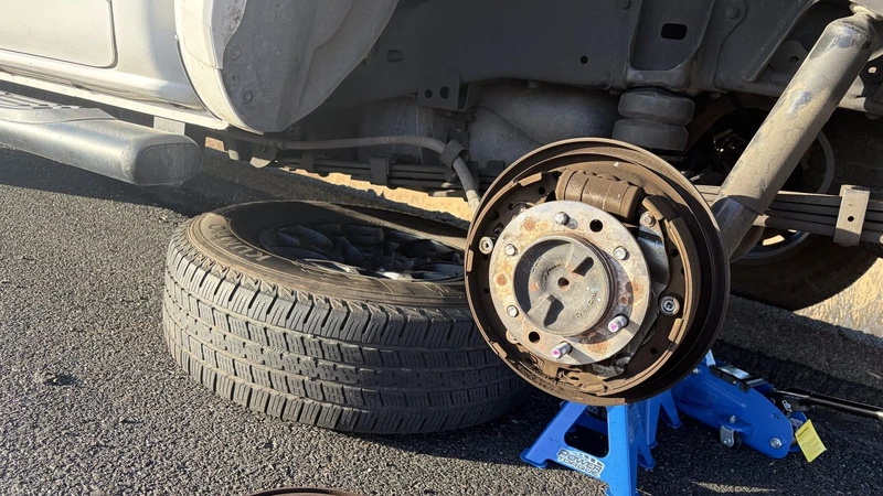 Mobile mechanic brake job on a pickup parked at the curb